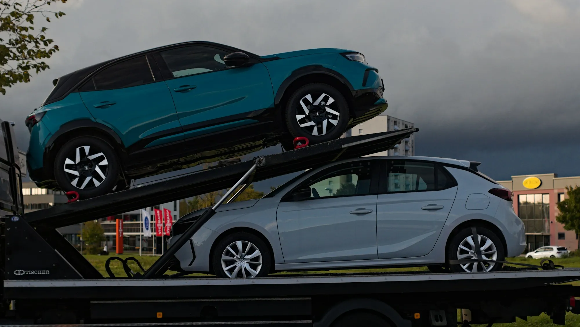 Car carrier truck hauling two cars on its upper and lower decks