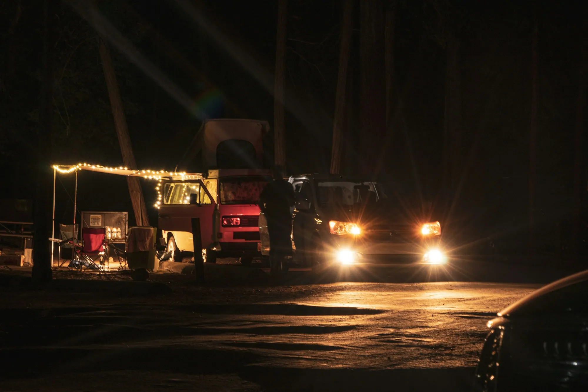 Tow truck with work lights on at a nighttime roadside call